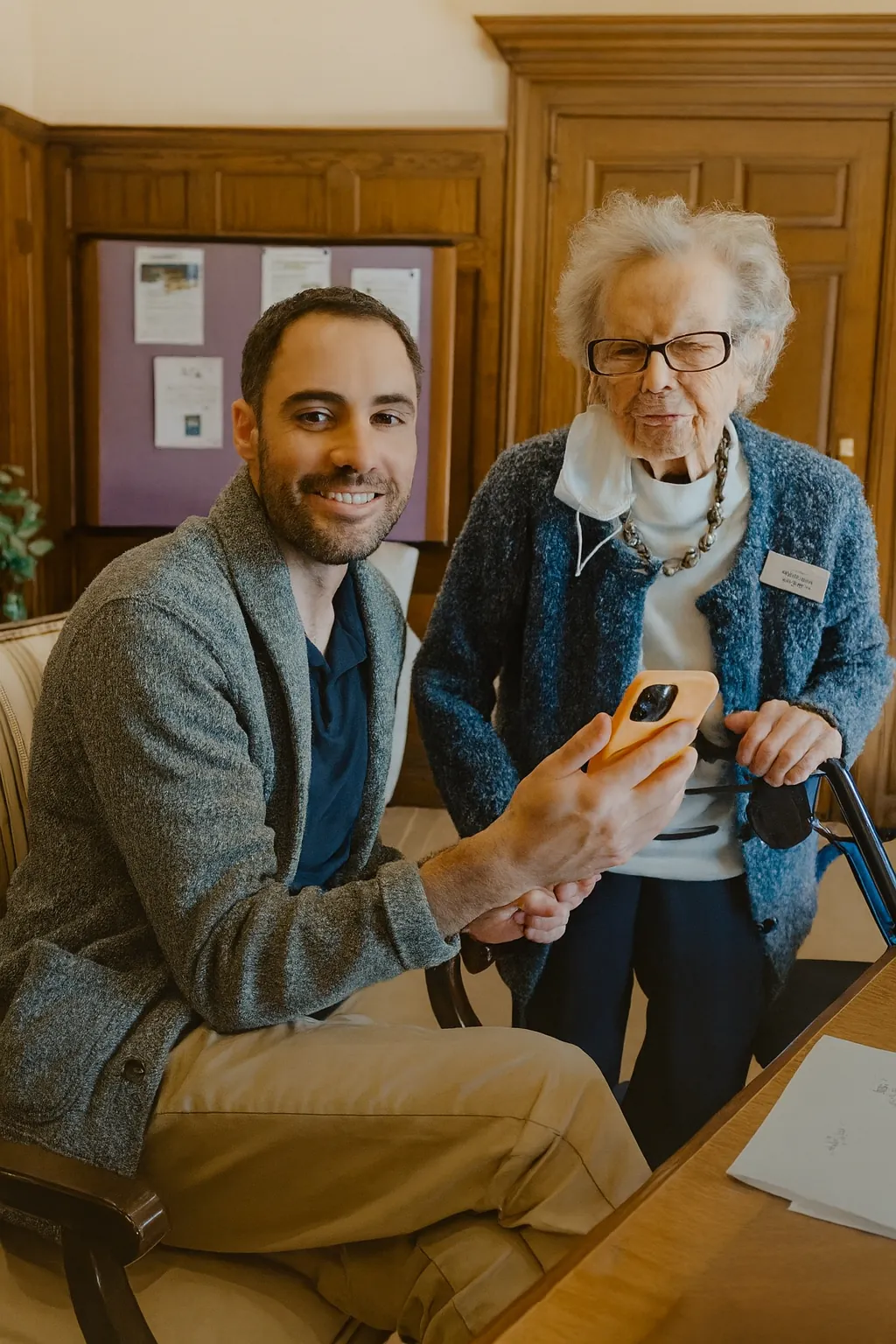 Instructor helping a senior with a smartphone